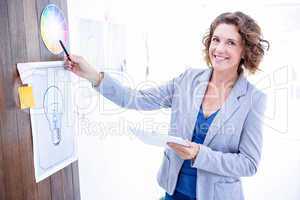 Creative businesswoman pointing color sample