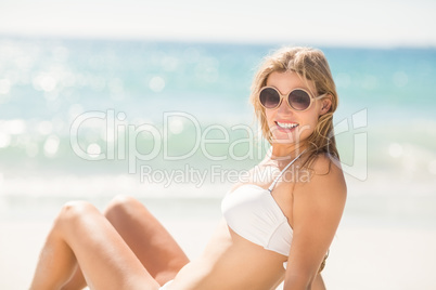 Happy pretty blonde looking at camera with sunglasses