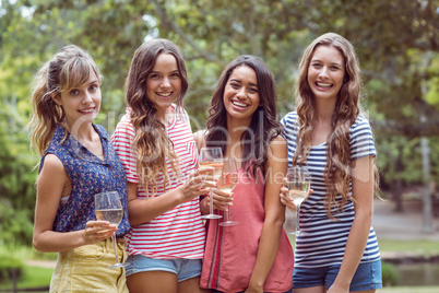 Happy friends drinking in the park