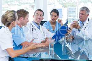 Team of doctors discussing about file