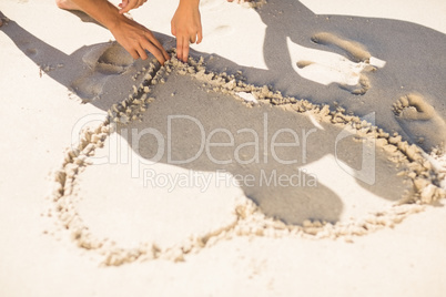 one heart drawn in the sand