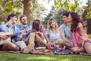 happy friends in a park having a picnic