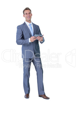 Happy businessman holding tablet computer