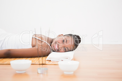 Peaceful pretty woman lying a bamboo mat