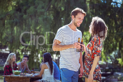 Happy friends in the park having lunch