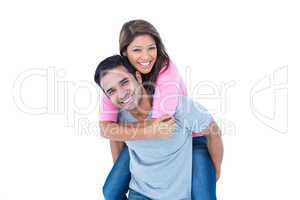 Happy man giving his girlfriend piggy back