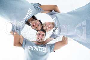 Happy volunteers forming huddle