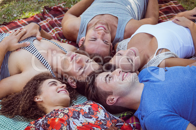 Happy friends in the park having picnic