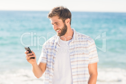 Happy man playing on his smartphone