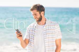 Happy man playing on his smartphone