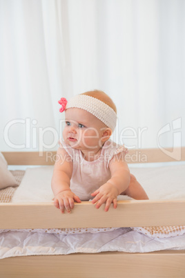 Beautiful baby girl in his bed