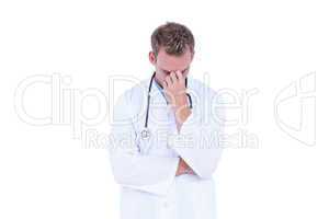 Worried young doctor with head in hand