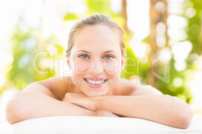 Close up portrait of a beautiful young woman on massage table