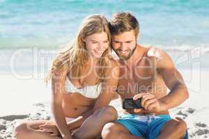 Happy couple looking at smartphone