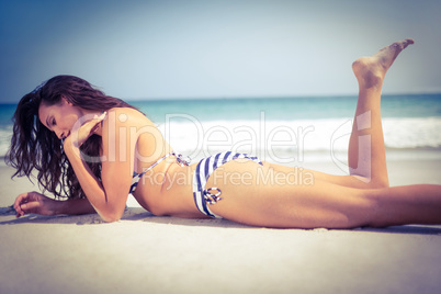 Pretty brunette posing at the beach
