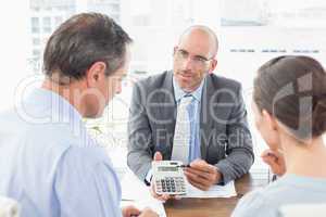 Businessman showing calculator to his clients