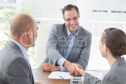 Businessman shaking hands with a businesswoman