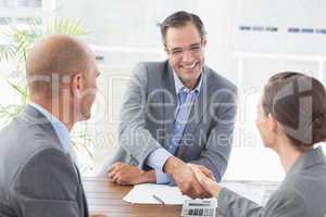 Businessman shaking hands with a businesswoman