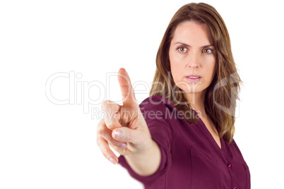 Serious woman pointing her finger at camera