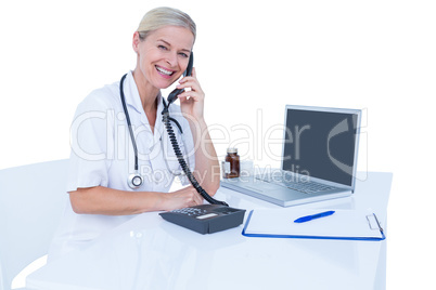 Smiling doctor having a phone call