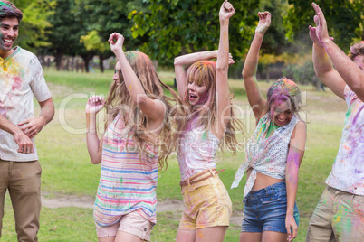 Happy friends covered in powder paint