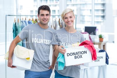 Volunteer couple holding donation boxes