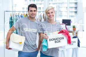 Volunteer couple holding donation boxes
