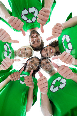 Friends wearing recycling tshirts forming huddle