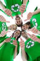 Friends wearing recycling tshirts forming huddle