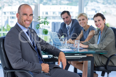 Businessman with his colleagues behind Businessman with his colleagues behind