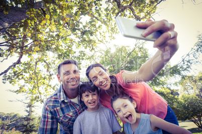 Happy family in the park taking selfie