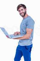 Happy handsome man holding laptop computer
