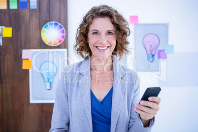 Creative businesswoman using her smartphone