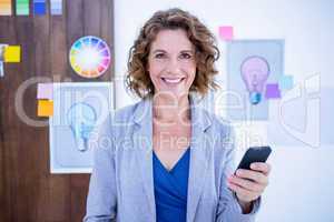 Creative businesswoman using her smartphone