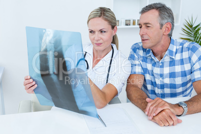 Doctor showing X rays to her patient