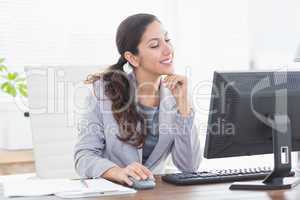 Smiling businesswoman using her computer