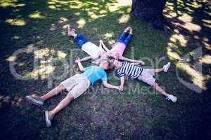Happy familly lying down in the park