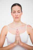 Fit woman meditating with hands crossed