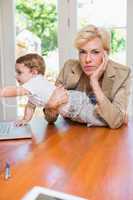 Blonde woman with his son using laptop