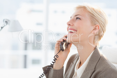 Smiling businesswoman on the phone