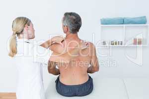 Doctor examining her patient back