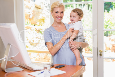 Blonde woman with his son using computer