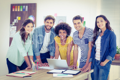 Group of young colleagues using laptop