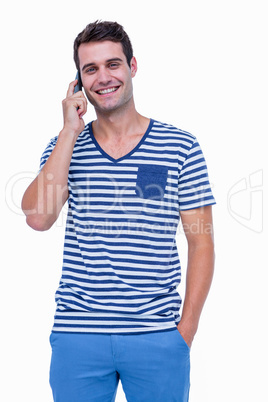 Handsome hipster smiling at camera and having a phone call