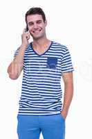 Handsome hipster smiling at camera and having a phone call