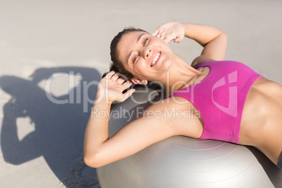 Fit woman stretching on exercise ball