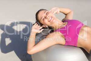 Fit woman stretching on exercise ball