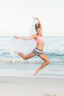 Beautiful woman jumping beside the sea