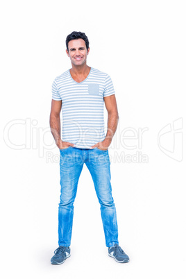 Happy man smiling at camera with hands in pocket