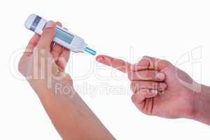 Diabetic woman using blood glucose monitor